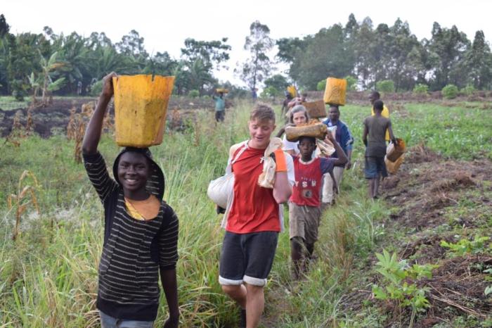 St Peters volunteers help local people carry materials to the project