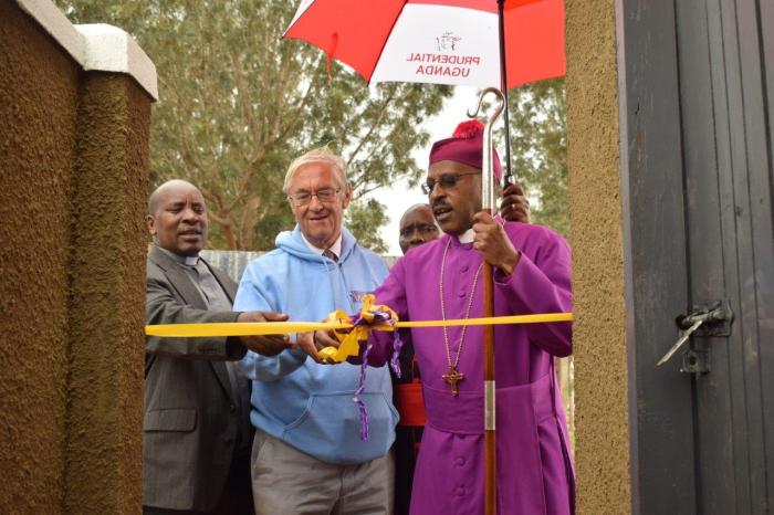 Ian Bensted, Bishop Benon Magezi and Eric Baingana cut the ribbon at Rumbugu