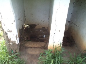 A filthy, crumbling latrine at Bwambara