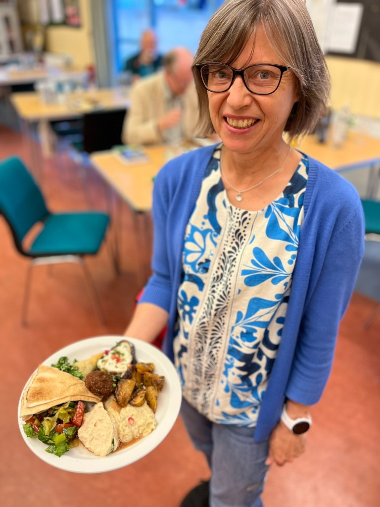 WATSAN Treasurer Ali with a plate of middle eastern food