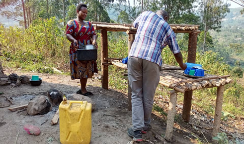 Woman next to dish-drying rack