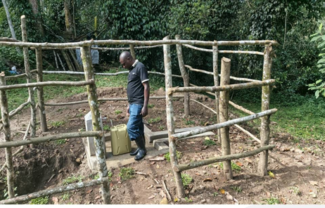 Man standing in fenced tapstand area